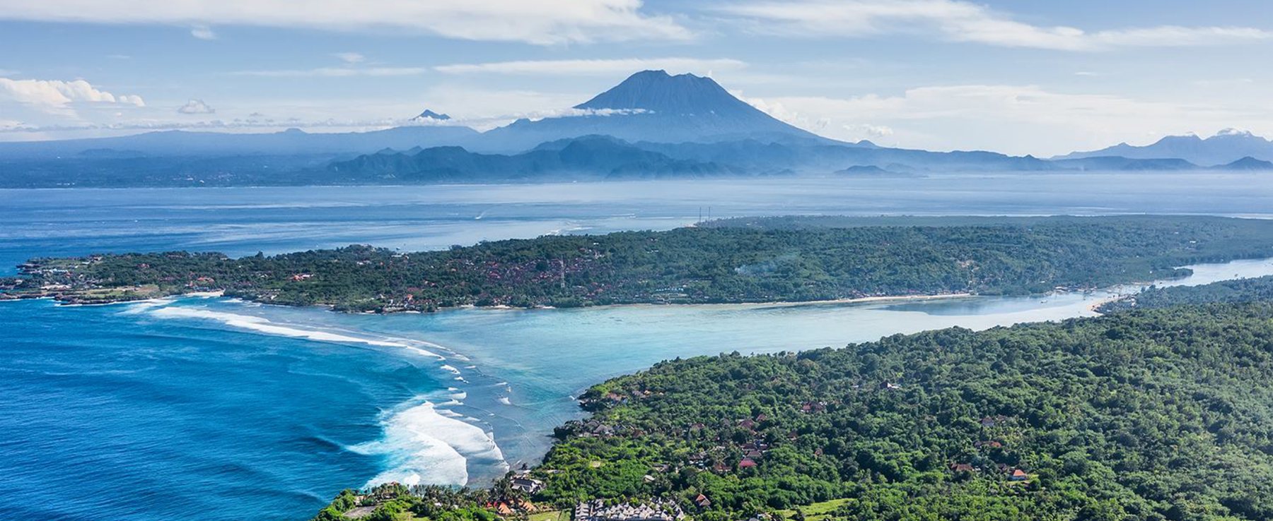 Mount Agung rising beyond the Nusa Penida coastline